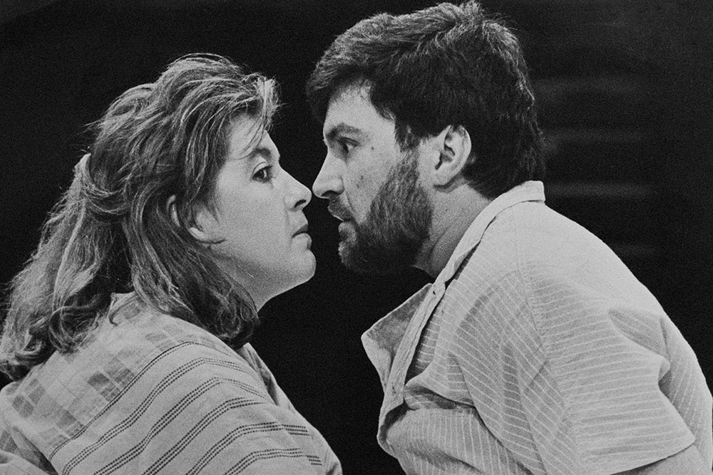 Production still for "A Bed of Ruses". L-R: Carole Patullo, Roger Selleck. Photographer: David B. Simmonds.