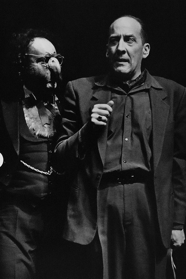 Production still for "A Dickins' Christmas". L-R: George Butrumlis as Parrot, Michael Carman as Fred. Photographer: Jeff Busby