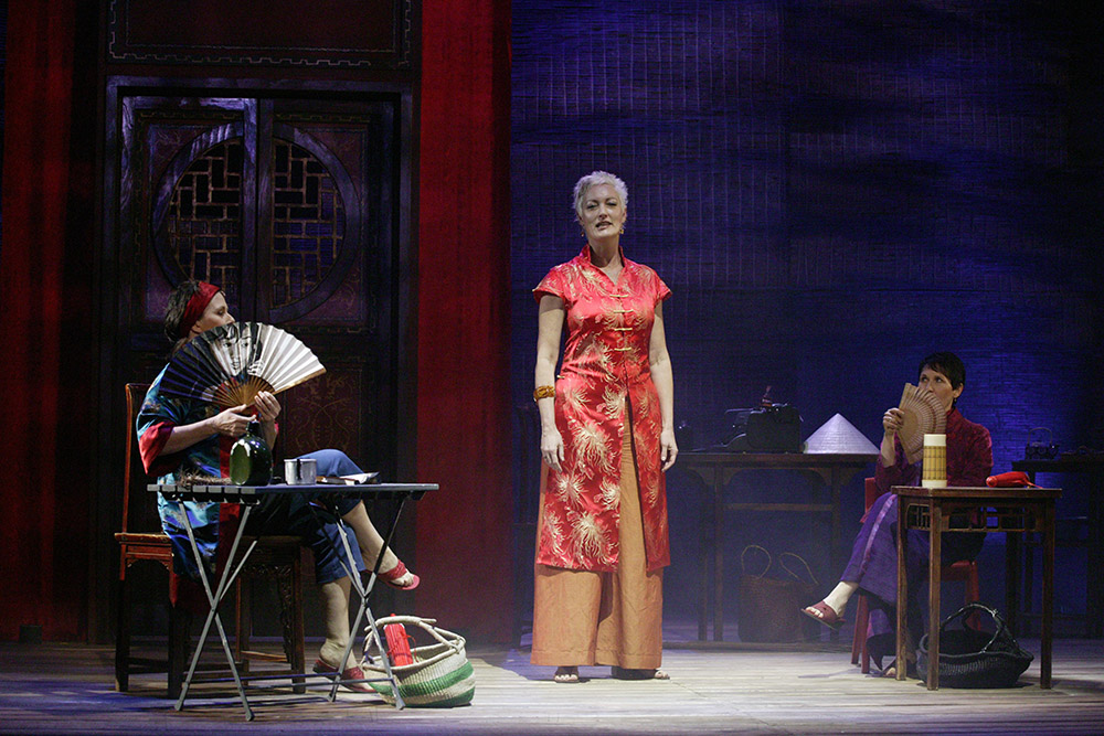 Production still for "Minefields and Miniskirts" (2004). L-R: Debra Byrne as The Nurse, Tracy Bartram as The Journalist, Robyn Arthur as The Volunteer. Photographer: Lisa Tomasetti